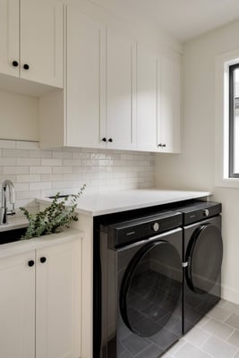 Bright Custom Homes stylish laundry remodel with washer and dryer in Bridgeland, Calgary