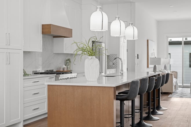 Elegant custom kitchen design with pendant lighting by Bright Custom Homes in Calgary