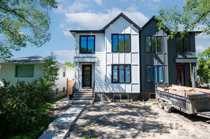 New construction duplex with sharp rooflines by Bright Custom Homes in Calgary