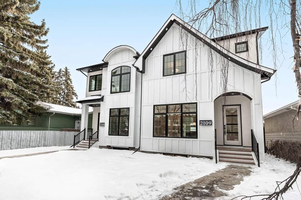 Two-story custom home build with unique roofline by Bright Custom Homes in Calgary
